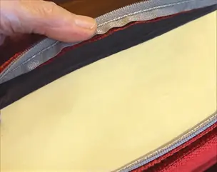 A pew cushion opened to reveal the foam inside